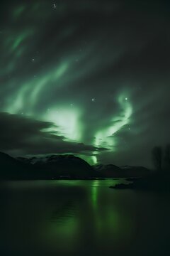 Vertical shot of the reflection of the Northern Lights over a sea at night