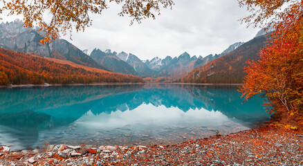 beautiful fairytale landscape in autumn in europe with a big blue lake of perfect crystal clear waters