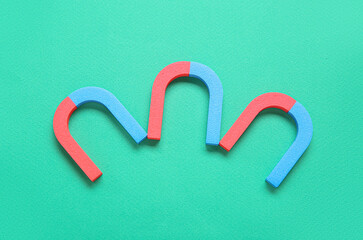 Horseshoe shaped magnets on green background