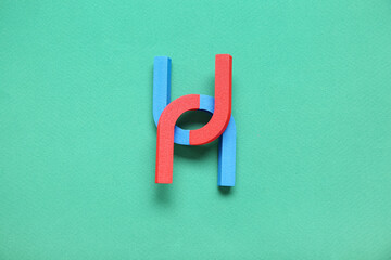 Horseshoe shaped magnets on green background