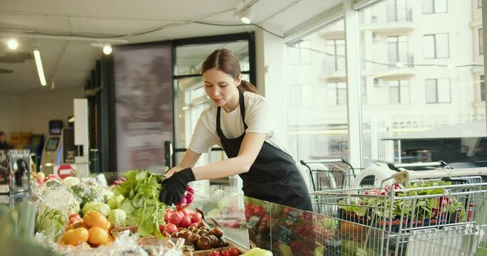 Caring Supermarket Employee: Smiling Girl Arranging Radishes with Love