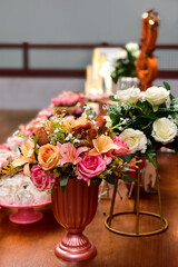 wedding table setting with flowers, cake and candy table, ornamental flowers