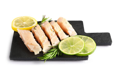 Slate board with pieces of codfish fillet on white background