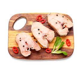 Wooden board with raw cut codfish on white background