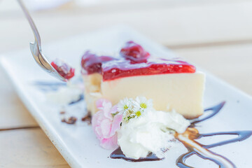 Appetizing white blueberry cake in a cafe next to the sea, Sue Flamingo, Ao Yon Beach, Phuket Thailand