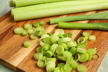 Board with slices of fresh leek, closeup