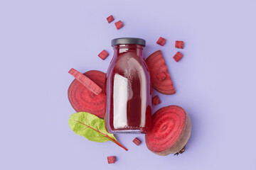 Bottle of healthy beet juice and spinach on lilac background