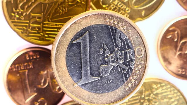 A One Euro Coin. Close-Up slow moving slider shot. Business and financial for saving or the investment background concept. Freshly minted moneys Macro shooting
