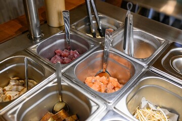 Closeup shot of different ingredients for a dish in a metal plate