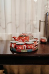 Closeup of red tea set on a table
