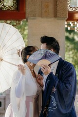 Vertical shot of a bride and a groom kissing each other
