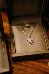 Vertical shot of a beautiful necklace in the brown box