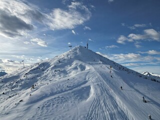 Fototapeta na wymiar Scenic shot of snow covered mountain slope for ski sports