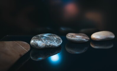 Line of pebbles on a dark glowing surface