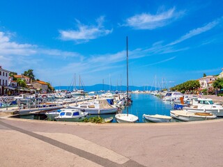 Fototapeta na wymiar Scenic view of small boats docked at a harbor seen on a sunny day