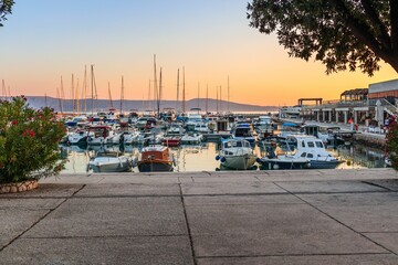 Boats in a harbor at sunset