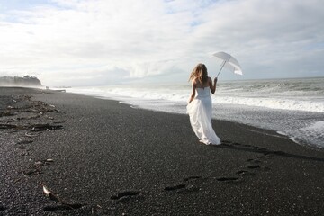 Beautiful view of a bride by the beach