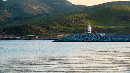 Gokceada Kalekoy port view with its green mountains and lighthouse in spring