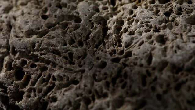 grey stone texture close-up. rought mountain surface. macro shot of a rock. natural mineral background. geological sample. 