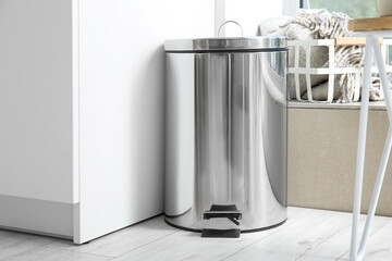 Metallic trash bin in interior of modern kitchen