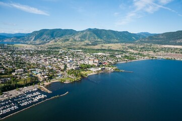 Aerial shot of the Okanagan Lake with Penticton city on the shore and hills in the background