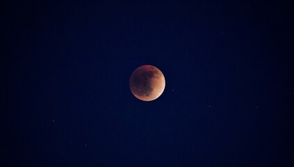Beautiful red moon shining in the starry dark sky for backgrounds and wallpapers