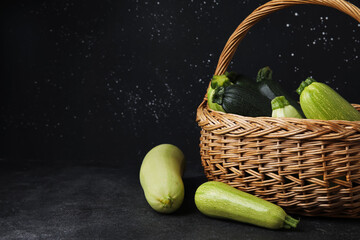 Wicker basket with fresh zucchini on grunge background