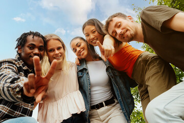 portrait of a multiracial group of friends looking at the camera and making gestures. Friendship and togetherness. Young people having a good time.