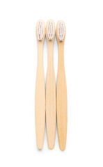 Bamboo toothbrushes on white background