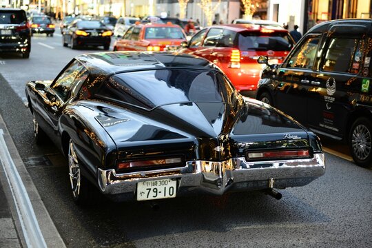 Back view of the Buick Riviera car in the streets of Japan