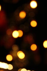 Vertical shot of the blurred bokeh lights in the darkness