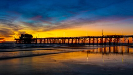 Distant shot of  a pier over a sea before the golden sunset in the evening