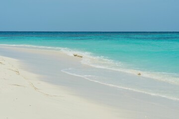 Scenic shot of waves crashing on the sandy beach of Maldives, cool for background