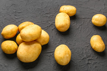 Raw baby potatoes on black background