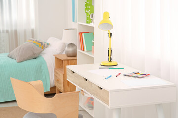 Stylish child room interior with comfortable workplace