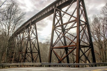 Low angle view of a rusted train track bridge through the Appalachian Mountains