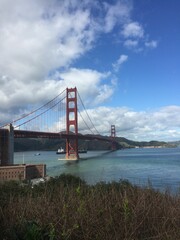 Vertical shot of the beautiful Golden Gate Bridge over the water in San Francisco