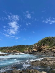 Fototapeta na wymiar Waves crashing over fascinating rock pools along Australias south coast