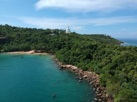 Aerial shot over the Rumassala Sanctuary near a jungle beach