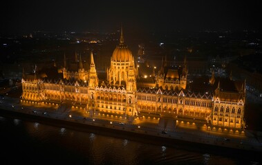 Naklejka premium Drone shot of the Palace of Parliament in Hungary, Budapest at night