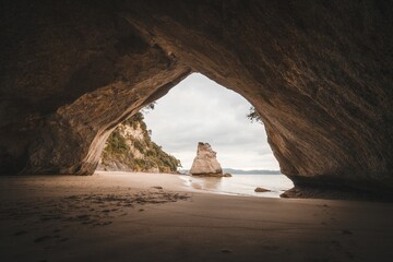 Sandy shore of a sea on an island seen from a cave