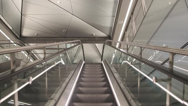Modern escalators in an empty building in cream shades