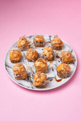 Sushi roll maki with proteins. Peruvian japanese cuisine.On a pink stone background.