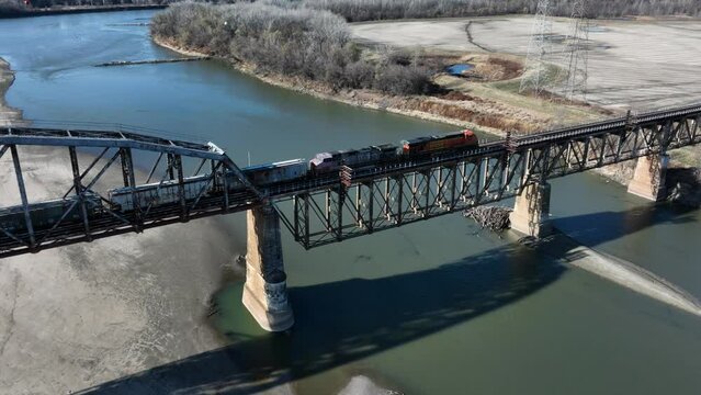 Aerial footage of BNSF freight train crossing the Sibley Bridge over the Missouri River