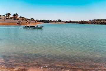 Boat with people riding in a lagoon in El Gouna, Red Sea, Egypt..