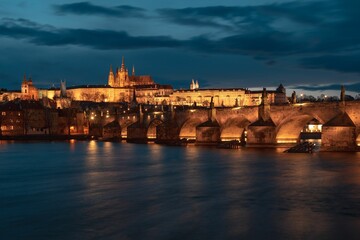 Fototapeta premium St. Vitus Cathedral with the Charles bridge at sunset in Prague by night