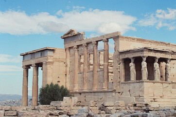 Naklejka premium Acropolis of Athens with a cloudy blue sky in the background, Greece
