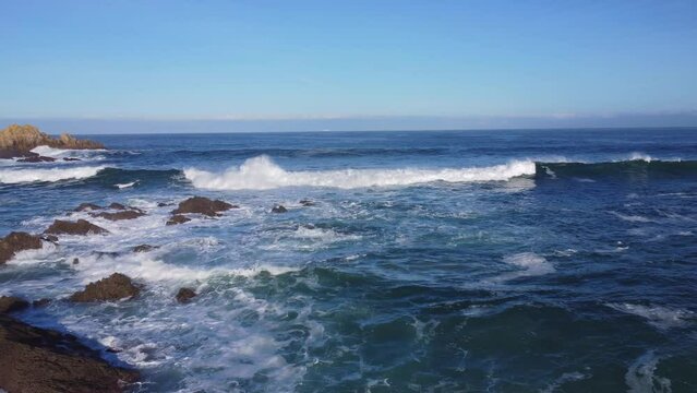 Slow motion of the foamy waves of the sea of the Ferrol Beach in Galicia, Spain during the daytime