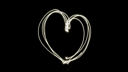 Illustrative white heart made of lights against black background