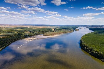 Aerial view of a river with with lush green vegetation on both sides